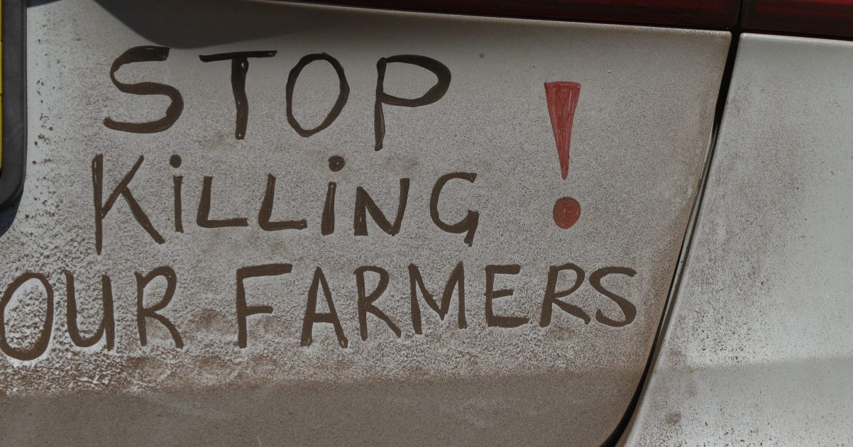 In this file photo dated Oct. 30 2017, a bumper sign calls for the end of farm killings in South Africa, during a blockade of a freeway in Midvaal, South Africa.
