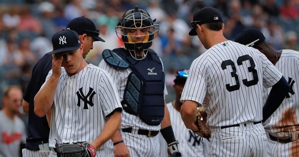 New York Yankees starting pitcher Sonny Gray, left, leaves the mound as he is relieved during the third inning of a baseball game against the Baltimore Orioles, Wednesday, Aug. 1, 2018, in New York.