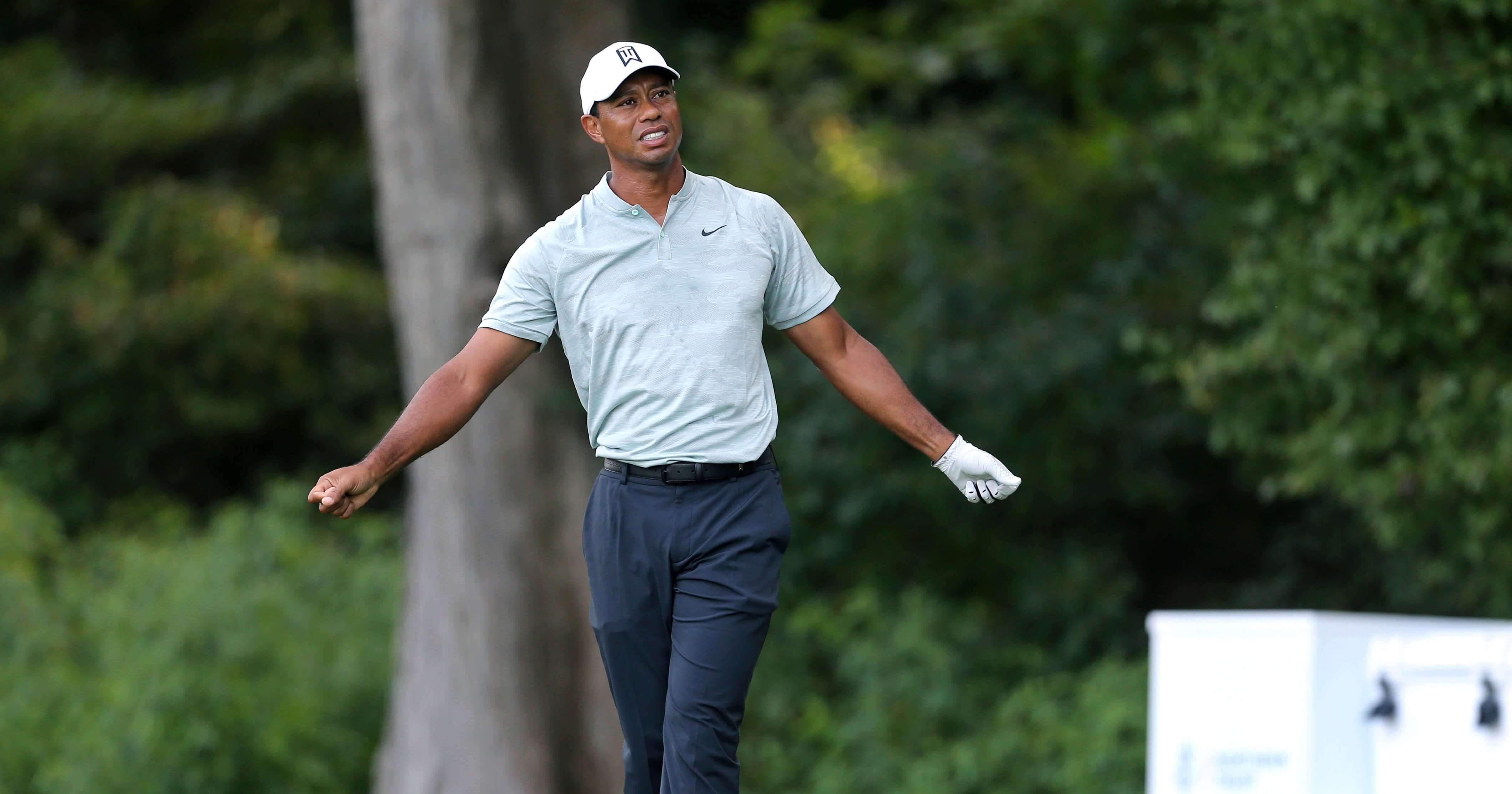 Tiger Woods reacts to his shot on the fourth hole during the third round of the Northern Trust golf tournament Saturday in Paramus, N.J.