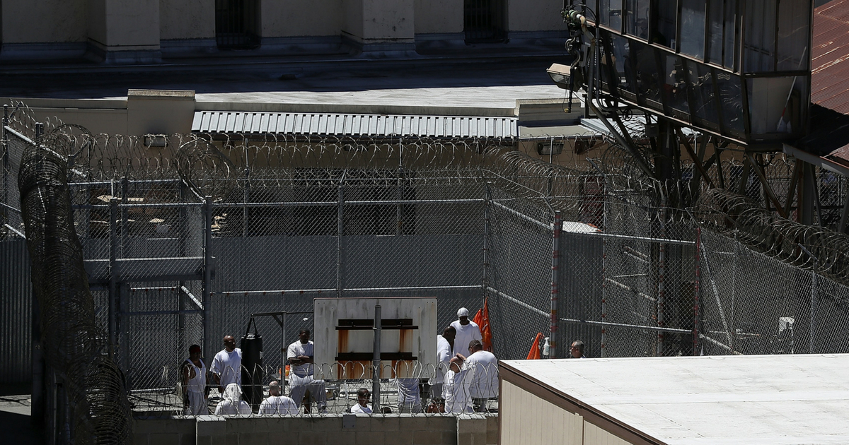 Condemned inmates stand in an exercise yard at San Quentin State Prison's death row on August 15, 2016 in San Quentin, California.