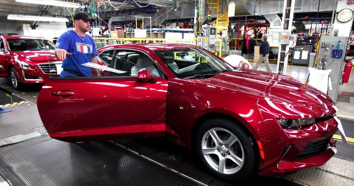 A GM worker puts the finishing touches on a new General Motors 2016 Chevrolet Camaro as it rolls off the production line at GM's Lansing Grand River Assembly Plant October 26, 2015 in Lansing, Michigan.