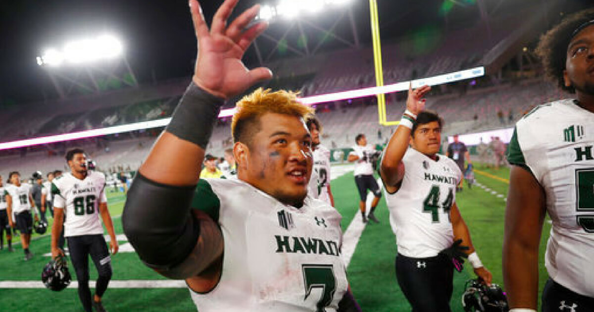 Hawaii running back Dayton Furuta waves to fans as he leaves the field after the team's NCAA college football game against Colorado State on Saturday, Aug. 25, 2018, in Fort Collins, Colo. Hawaii won 43-34.