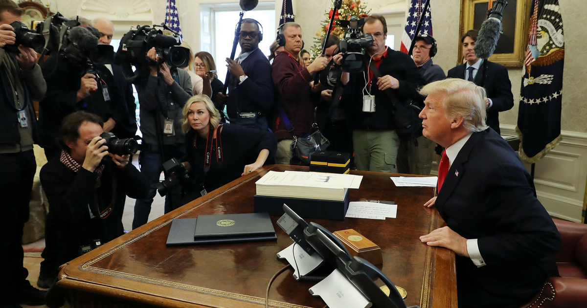 U.S. President Donald Trump talks with journalists after signing tax reform legislation into law in the Oval Office December 22, 2017 in Washington, DC. Trump praised Republican leaders in Congress for all their work on the biggest tax overhaul in decades.