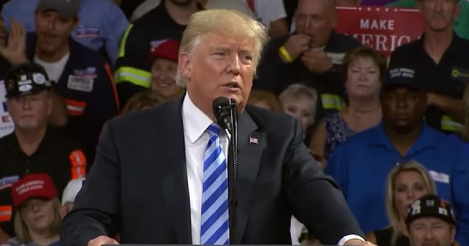 President Trump stands at a dais.