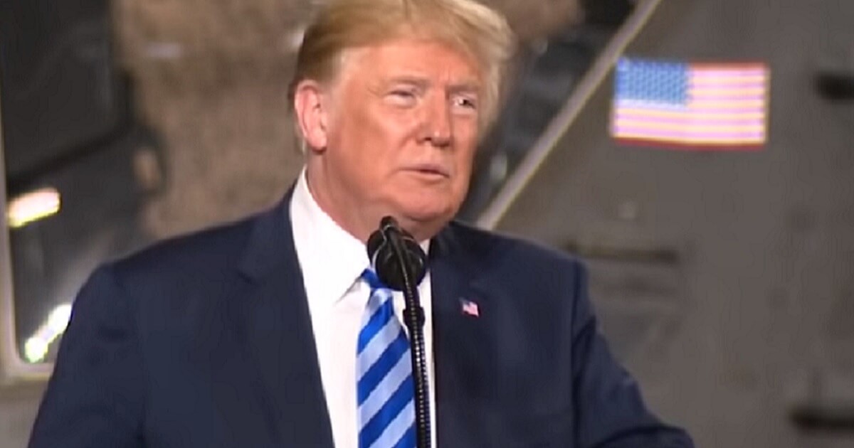 President Trump speaking into a microphone