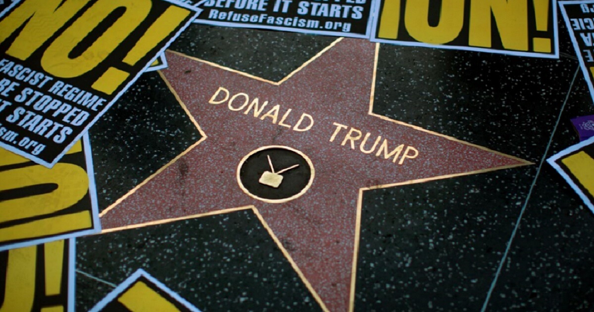 Donald Trump's star surrounded by protest posters.