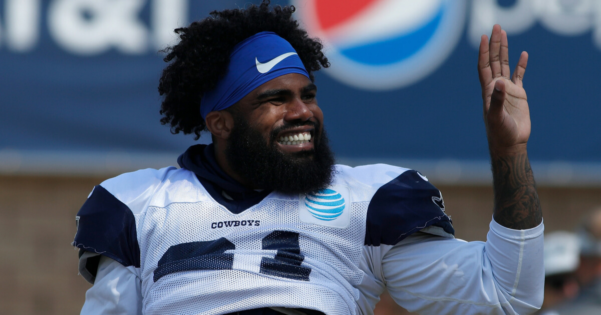 Ezekiel Elliott #21 of the Dallas Cowboys waves to the crowd during training camp at River Ridge Playing Fields on August 2, 2018 in Oxnard, California.