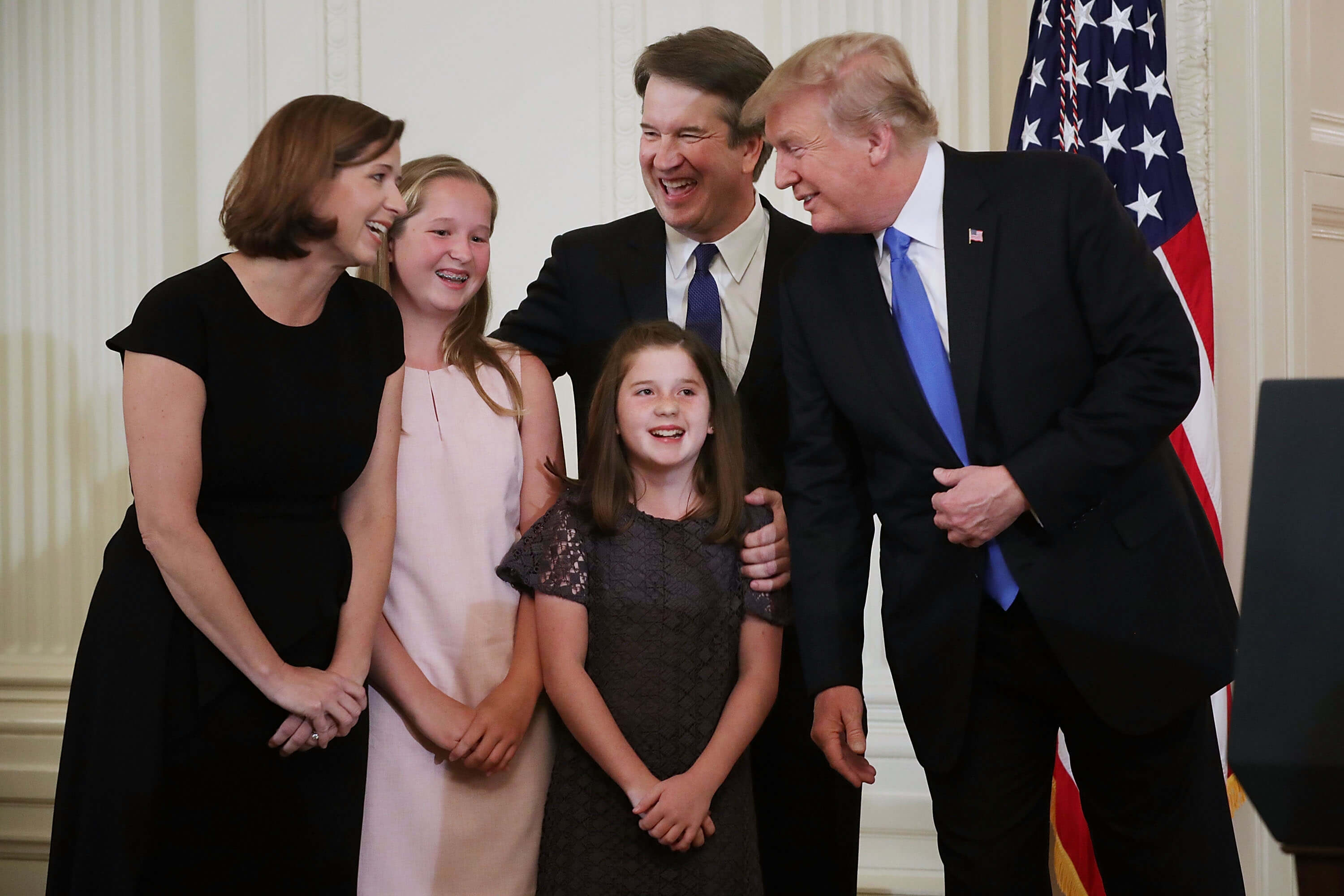 U.S. President Donald Trump (R), Judge Brett M. Kavanaugh (2nd R), his wife Ashley Estes Kavanaugh and their daughters, Margaret and Liza, share a laugh after Trump announced the judge as his nominee to the United States Supreme Court during an event in the East Room of the White House July 9, 2018 in Washington, DC.
