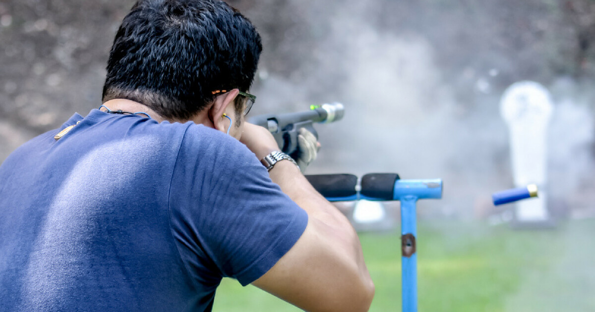 A man shoots a rifle at a gun range