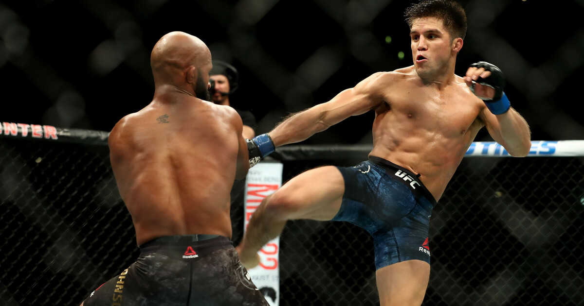 Henry Cejudo kicks Demetrious Johnson in the second round of the UFC Flyweight Title Bout during UFC 227 at Staples Center on Aug. 4, 2018, in Los Angeles.