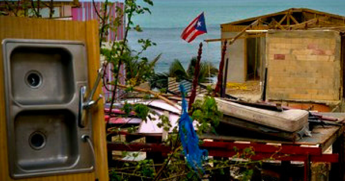 A Puerto Rican national flag is mounted on debris of a damaged home in the aftermath of Hurricane Maria in the seaside slum La Perla, San Juan, Puerto Rico.