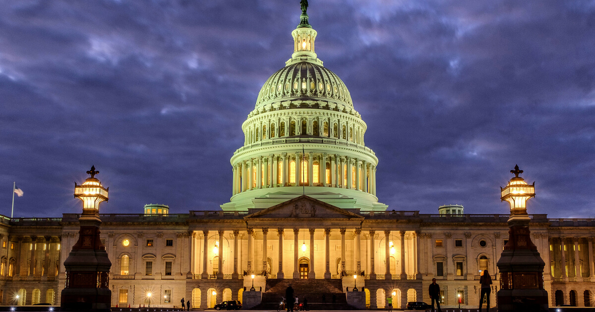 Lights shine inside the U.S. Capitol Building as night falls in Washington