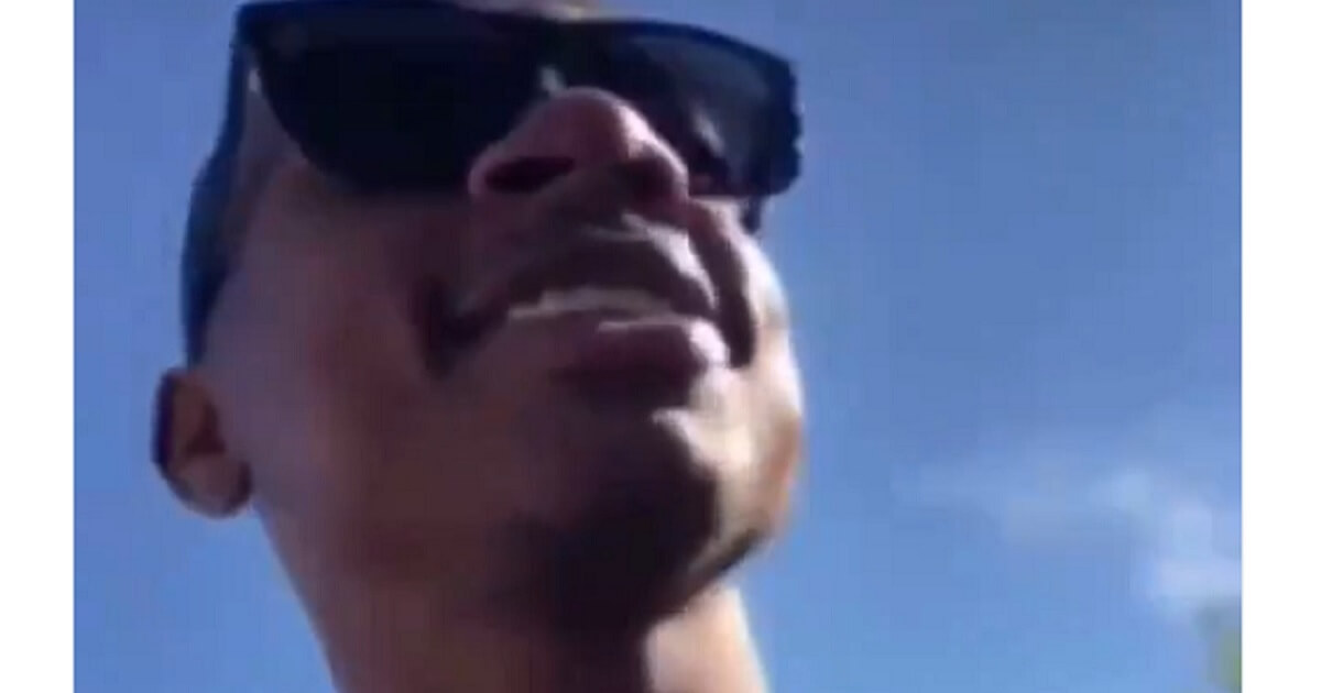 Isaiah Thomas looking away from the camera with sunglasses on.