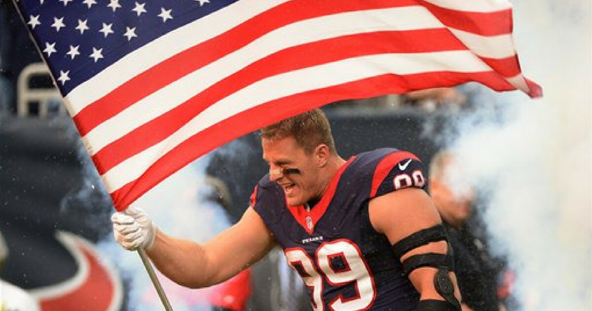 Houston Texans defensive end J.J. Watt (99) carries a flag during introductions before an NFL football game.