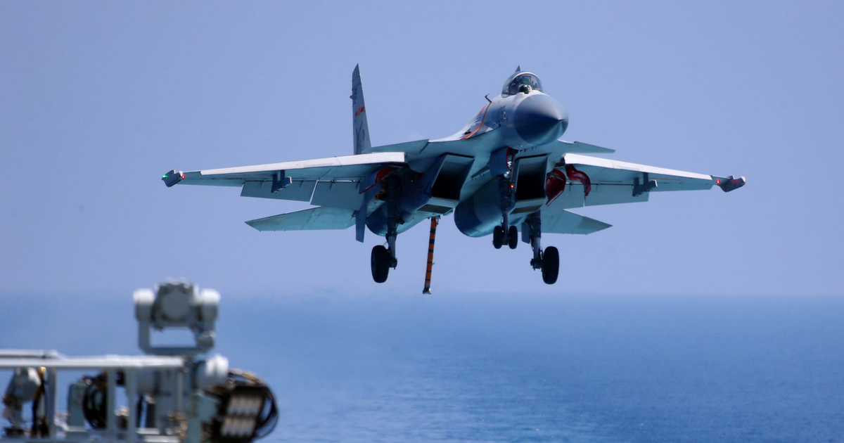 This photo taken on April 14, 2018 shows a J15 fighter jet preparing to land on China's sole operational aircraft carrier, the Liaoning, during a drill at sea.