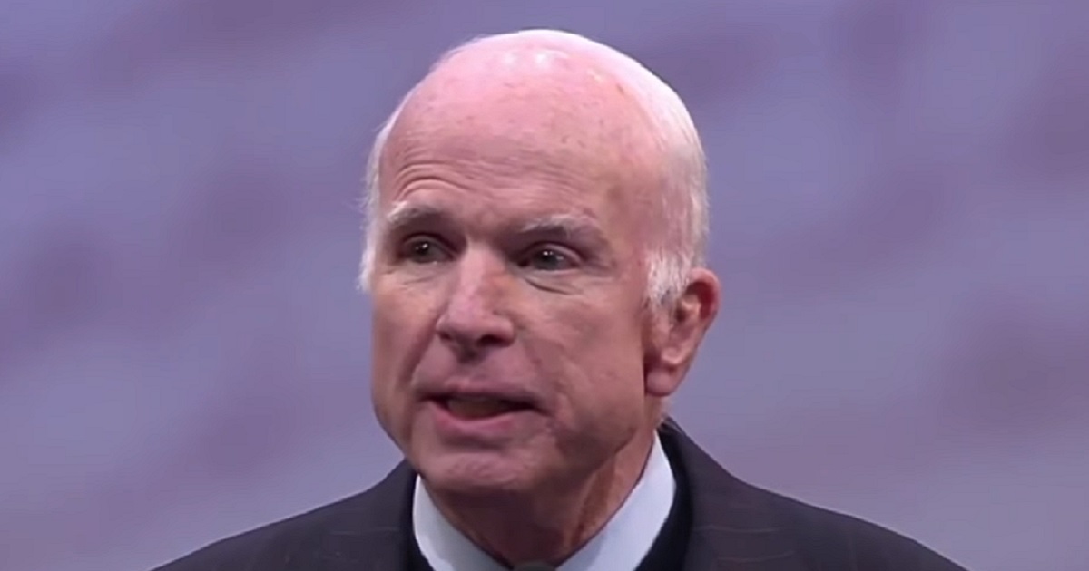 McCain alone on a stage.