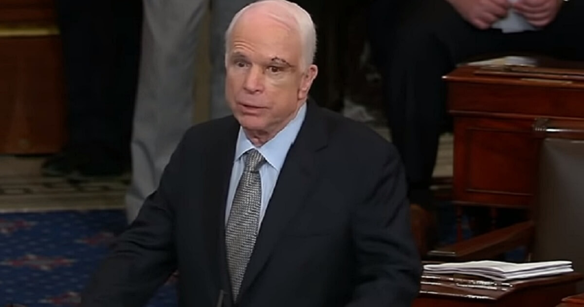 John McCain standing at dais.