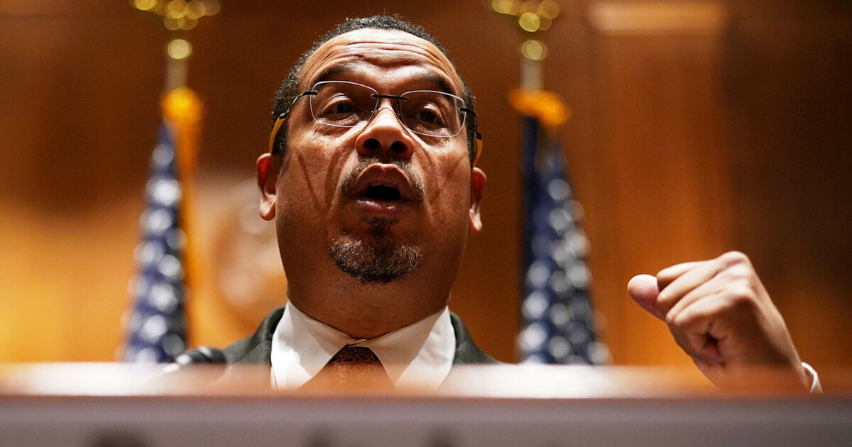 Ellison at a podium.