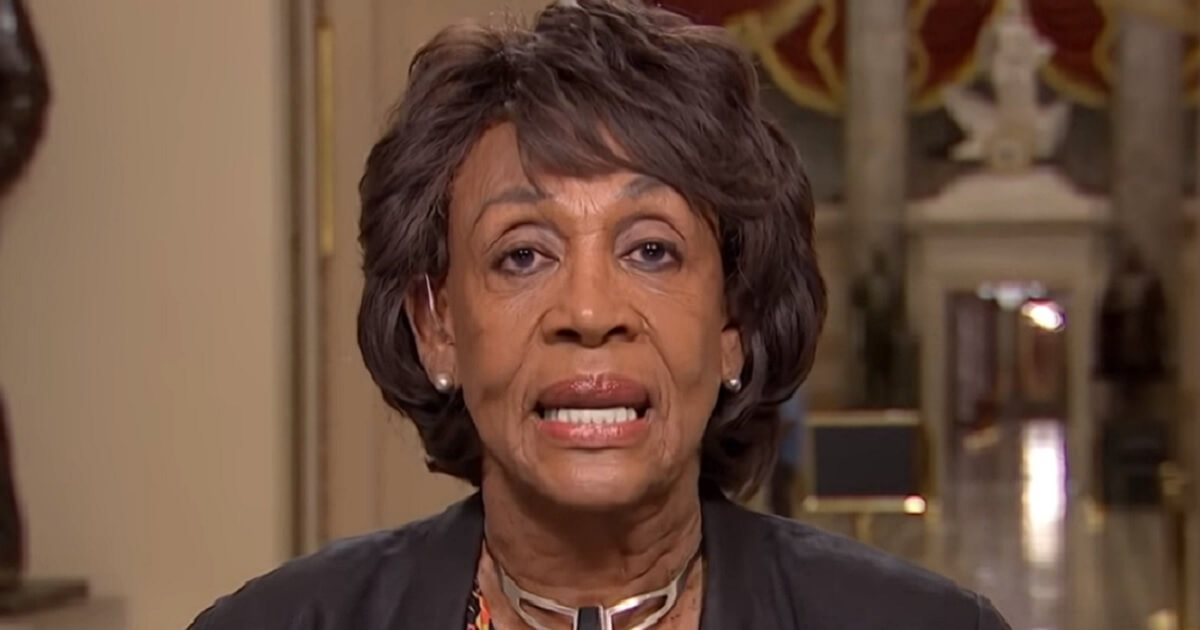 Maxin Waters speaks into a camera.