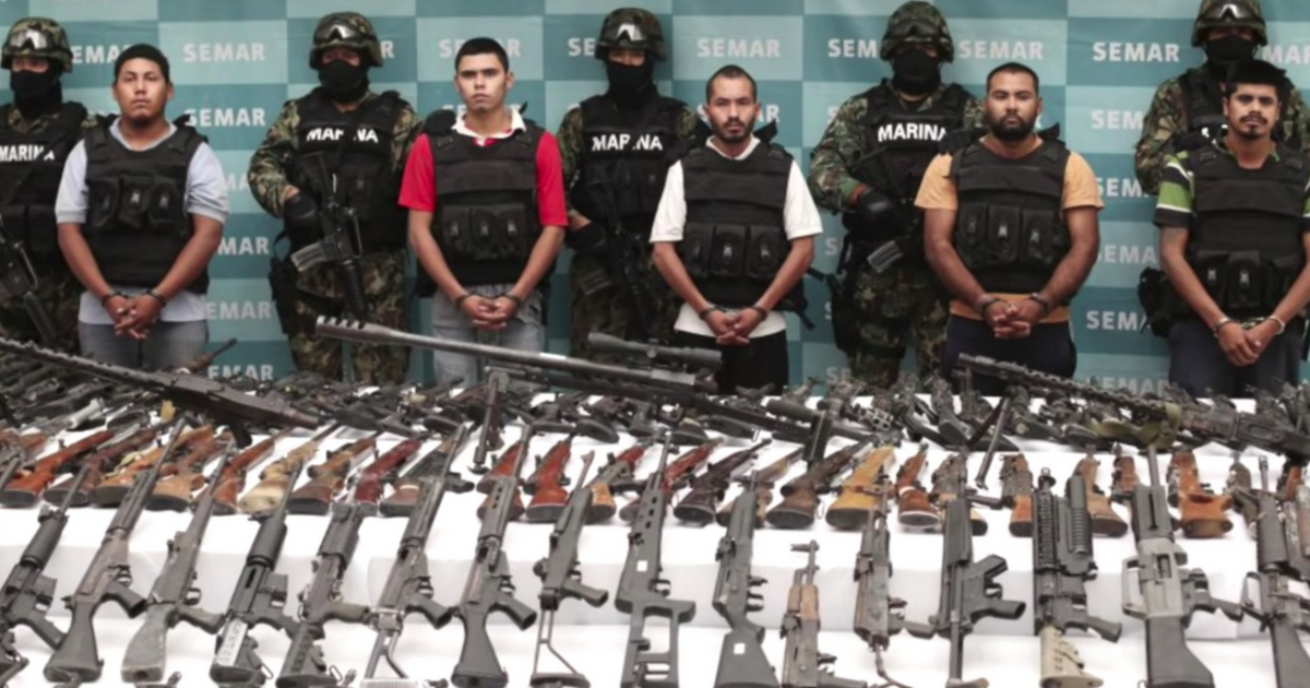 Members of a Mexican drug cartel pose after being arrested