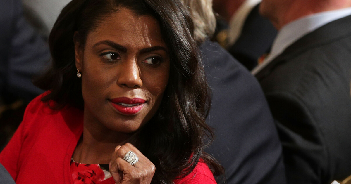 Omarosa Manigault has an expression of intense interest at the briefing.