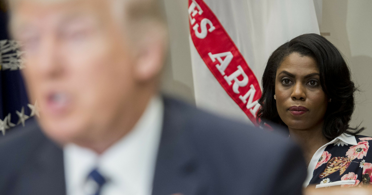 Omarosa Manigault (R), White House Director of Communications for the Office of Public Liaison, sits behind US President Donald Trump as he speaks during a meeting with teachers, school administrators and parents in the Roosevelt Room of the White House in Washington, D.C., February 14, 2017.