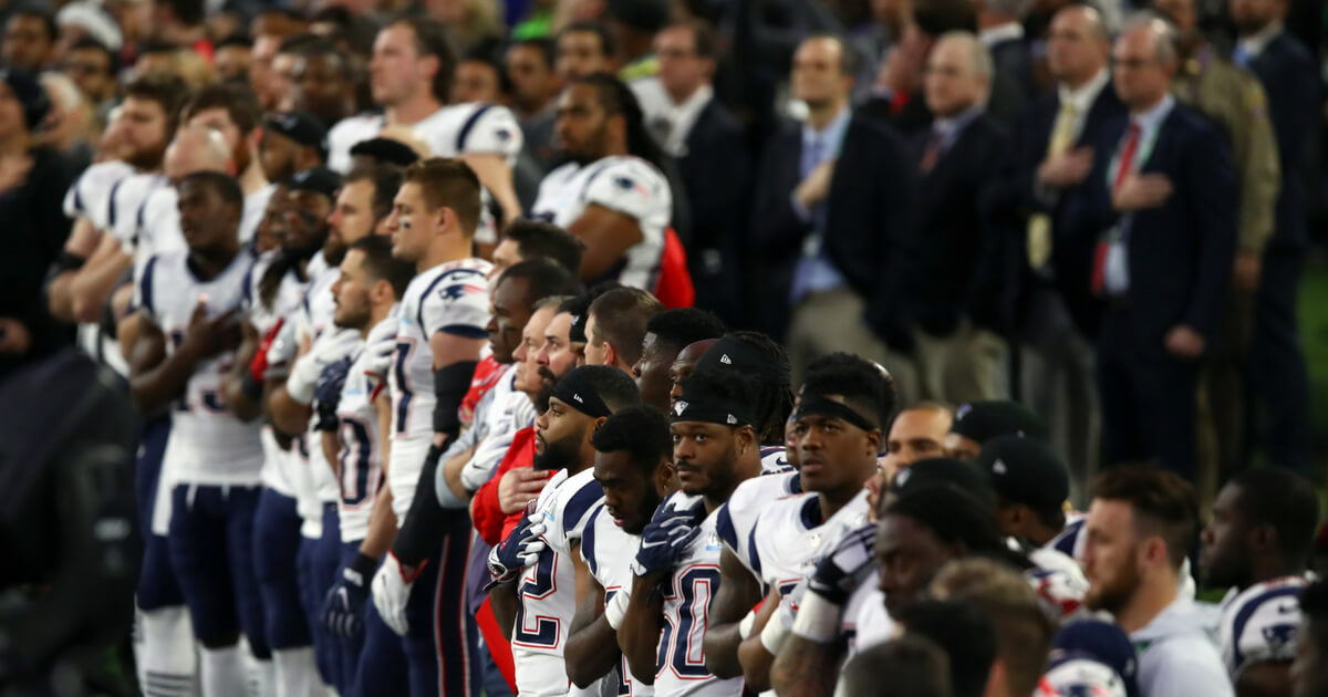 The New England Patriots stand during the national anthem prior to Super Bowl LII against the Philadelphia Eagles at U.S. Bank Stadium on Feb. 4 in Minneapolis.