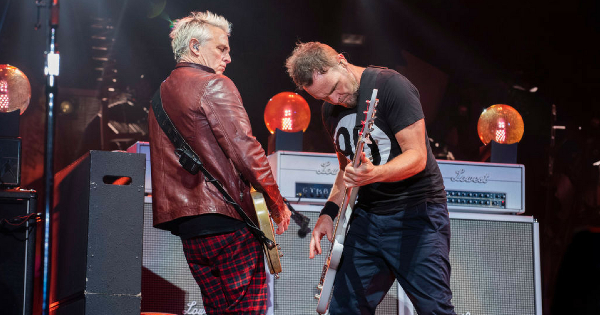 Lead guitarist Mike McCready (L) and bassist Jeff Ament of Pearl Jam perform live on stage