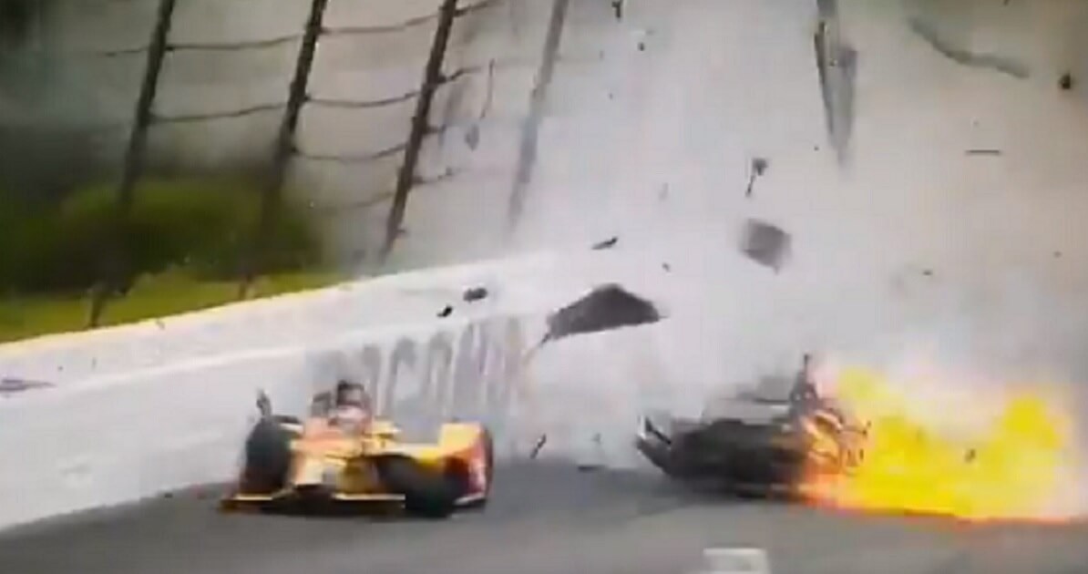 Car on racetrack in flames.