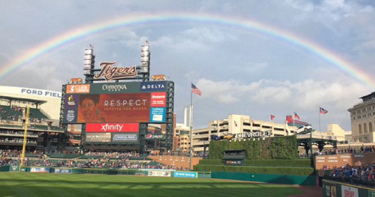 A rainbow soars over a ballpark.