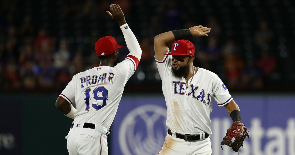 Jurickson Profar, left, and Rougned Odor of the Texas Rangers celebrate a triple play against the Los Angeles Angels in the fourth inning at Globe Life Park in Arlington on Aug. 16 in Arlington, Texas.