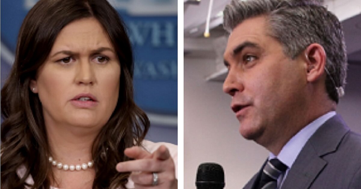 Sarah Sanders, left, and Jim Acosta holding microphone