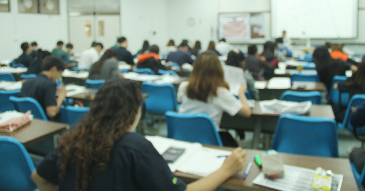 Students take notes during a classroom lecture