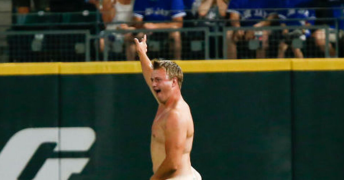 A streaker runs across right field during the ninth inning of the game between the Toronto Blue Jays and Seattle Mariners at Safeco Field