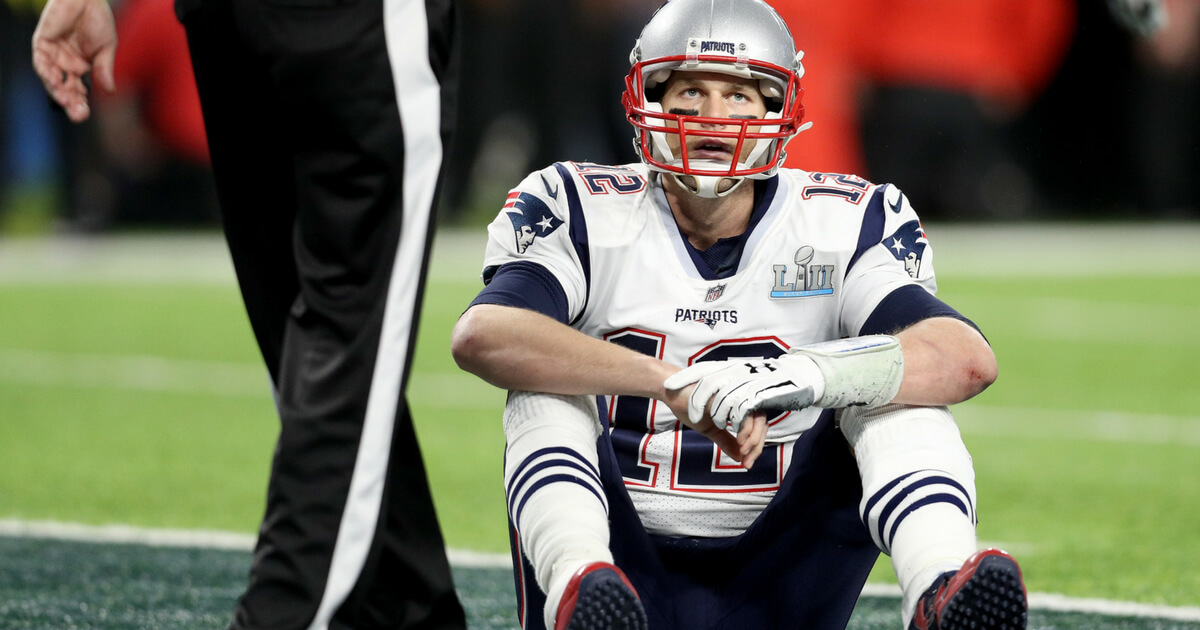 Tom Brady #12 of the New England Patriots reacts after fumbling against the Philadelphia Eagles during the fourth quarter in Super Bowl LII at U.S. Bank Stadium on February 4, 2018 in Minneapolis, Minnesota.