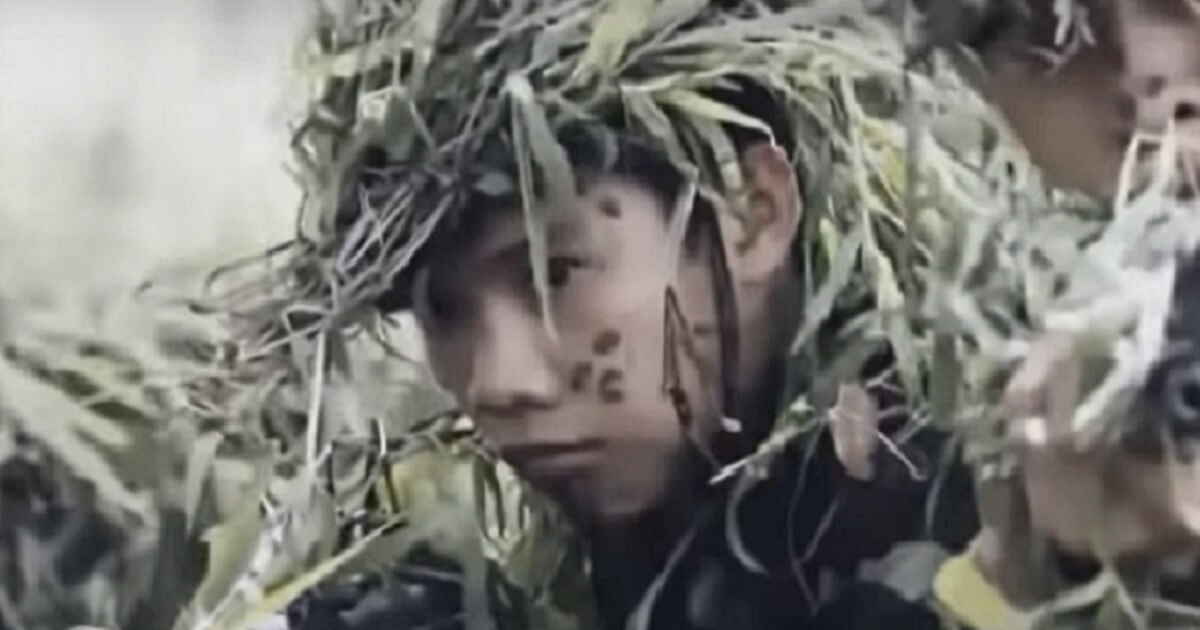 Vietnamese soldier hiding in grass