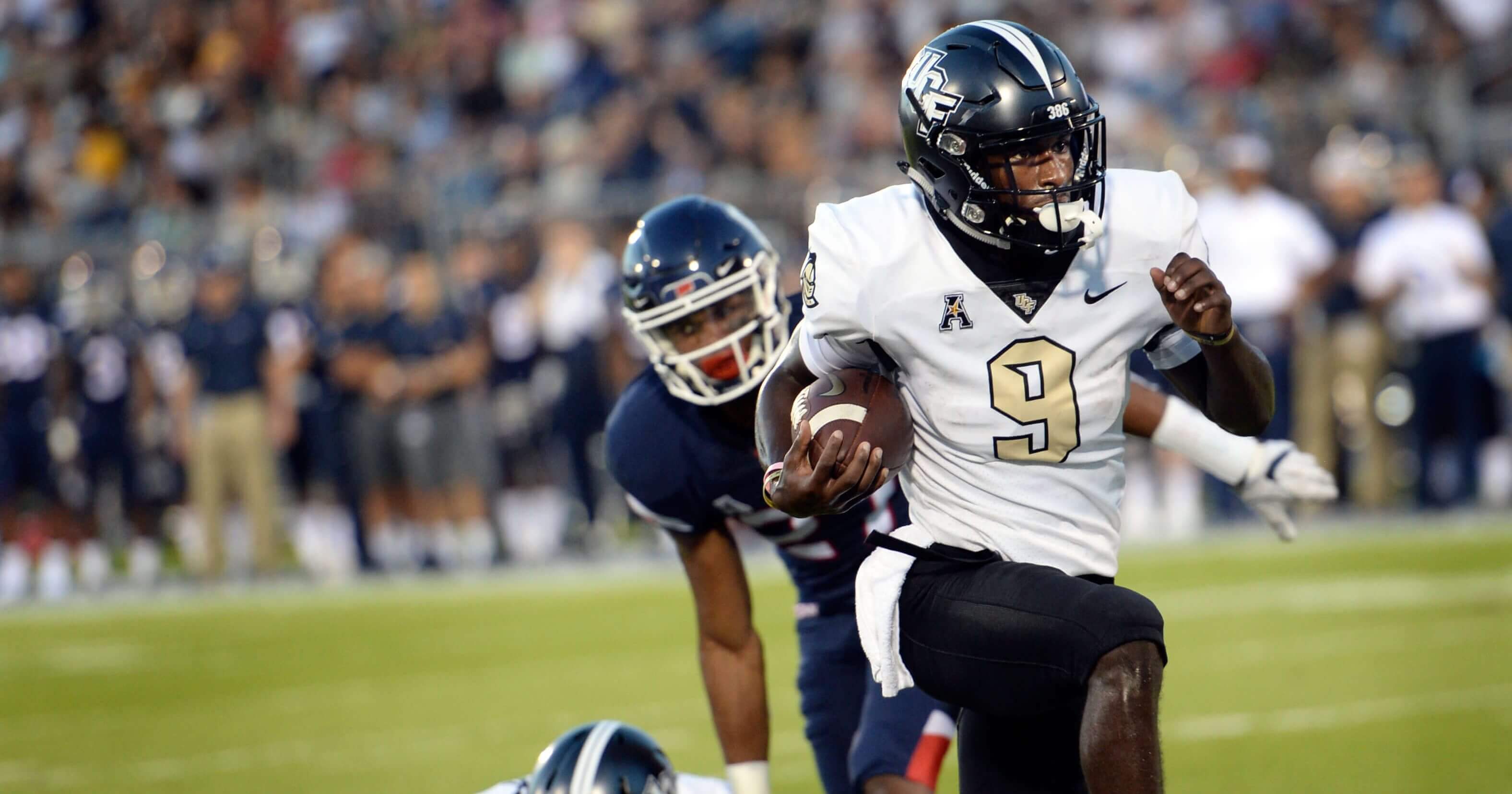 Central Florida running back Adrian Killins Jr. (9) runs the ball in for a touchdown during the first half of an NCAA college football game against Connecticut on Thursday in East Hartford, Conn.