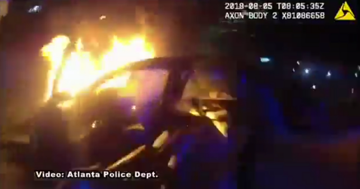 A car on fire after an accident.
