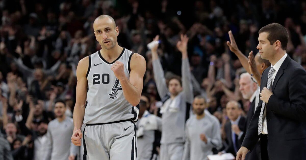 San Antonio Spurs guard Manu Ginobili (20) pumps his fist after hitting the winning shot in the final seconds of the team's NBA basketball game against the Boston Celtics.