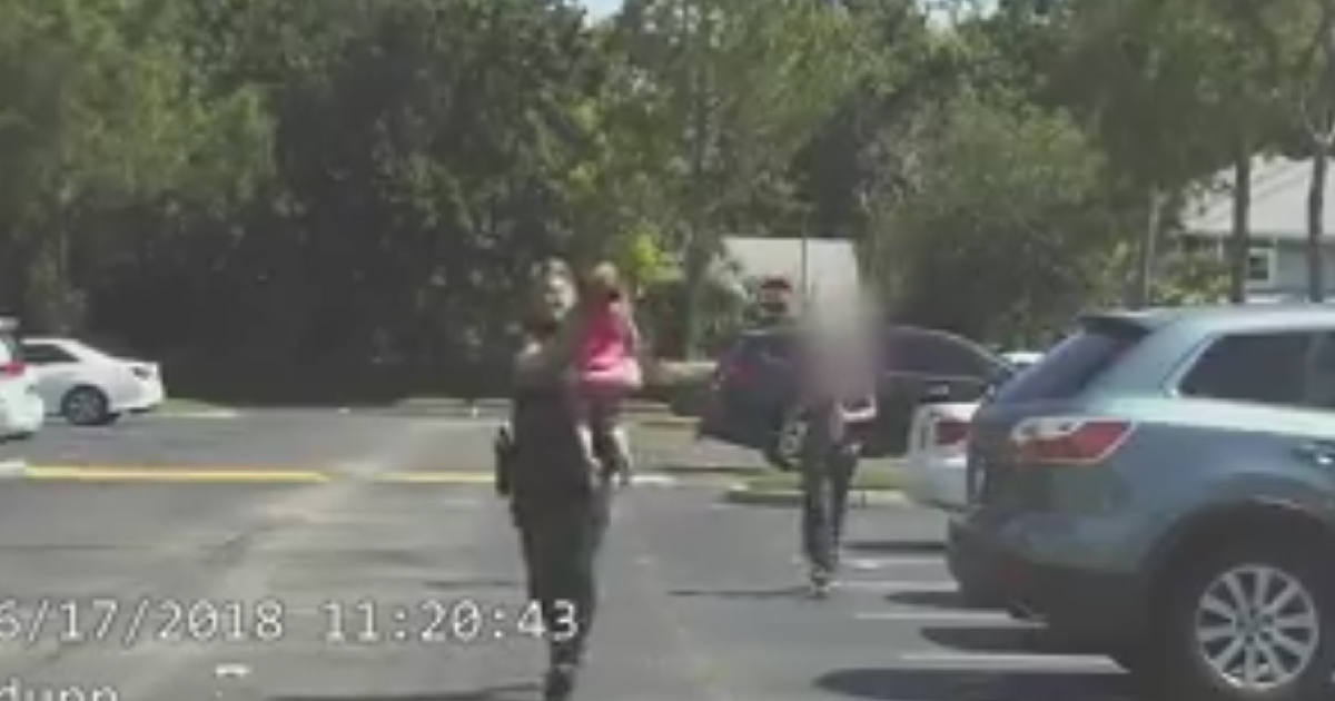 Dashcam footage of deputy running with a child in his arms