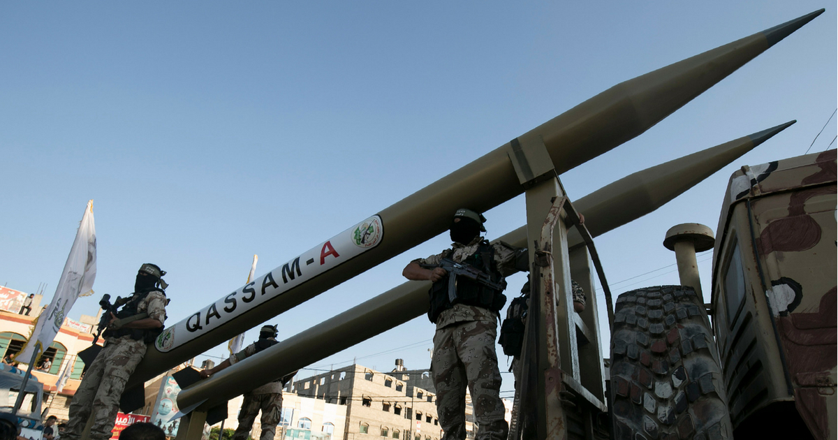 Palestinian members of the al-Qassam Brigades, the armed wing of the Hamas movement, display Qassam home-made rockets during an anti-Israel military parade