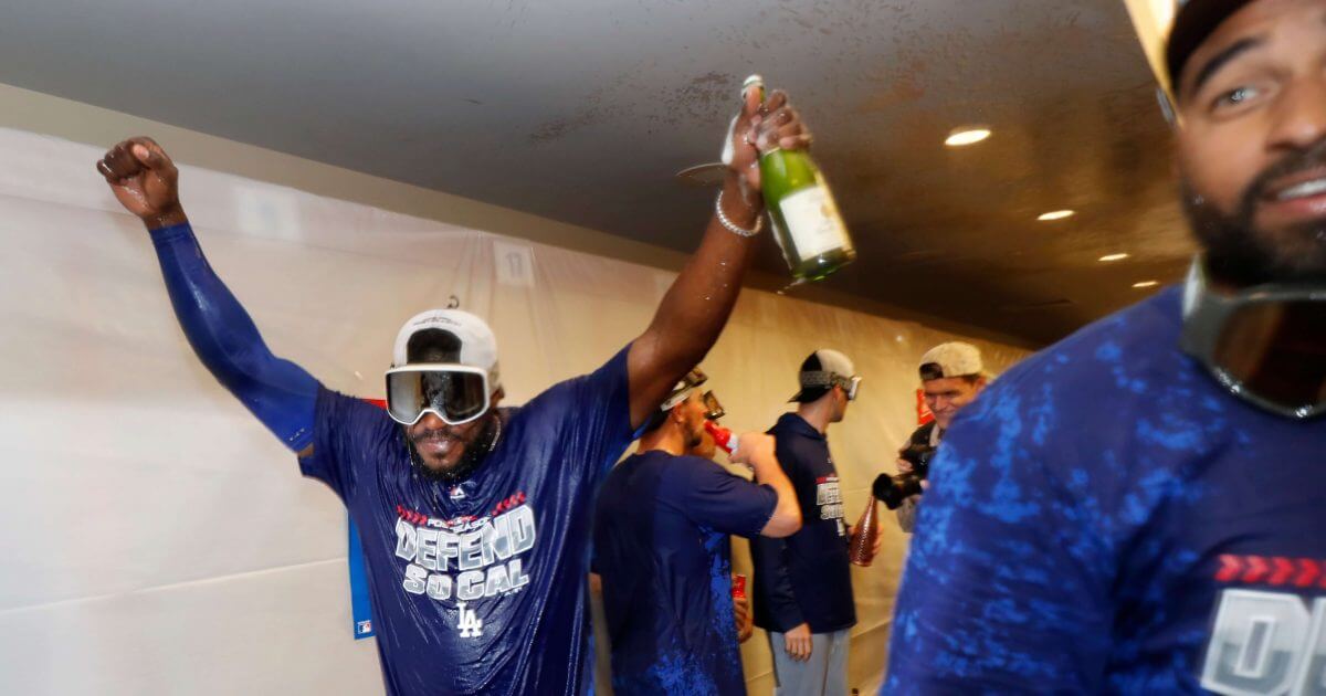 The Los Angeles Dodgers' Yasiel Puig celebrates clinching a playoff spot after beating the San Francisco Giants on Saturday.