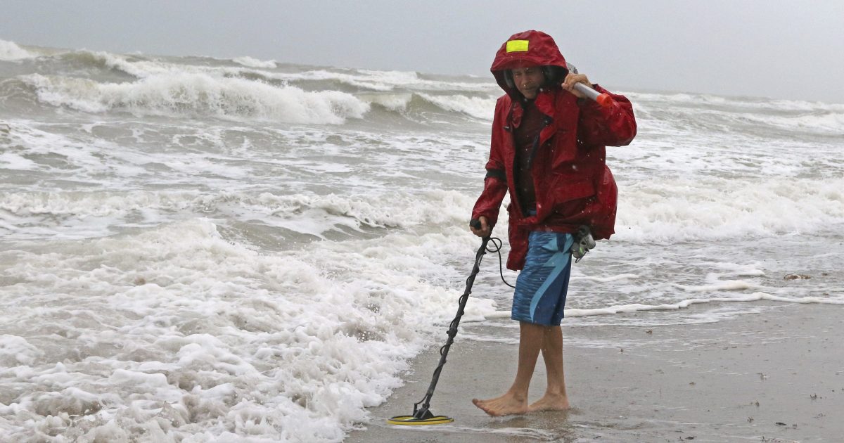 Local resident Mike Squillace looks for metal at Dania Beach, Fla., as Tropical Storm Gordon passes by South Florida with wind gust and heavy rainfall for the Labor Day holiday on Monday, Sept. 3, 2018.