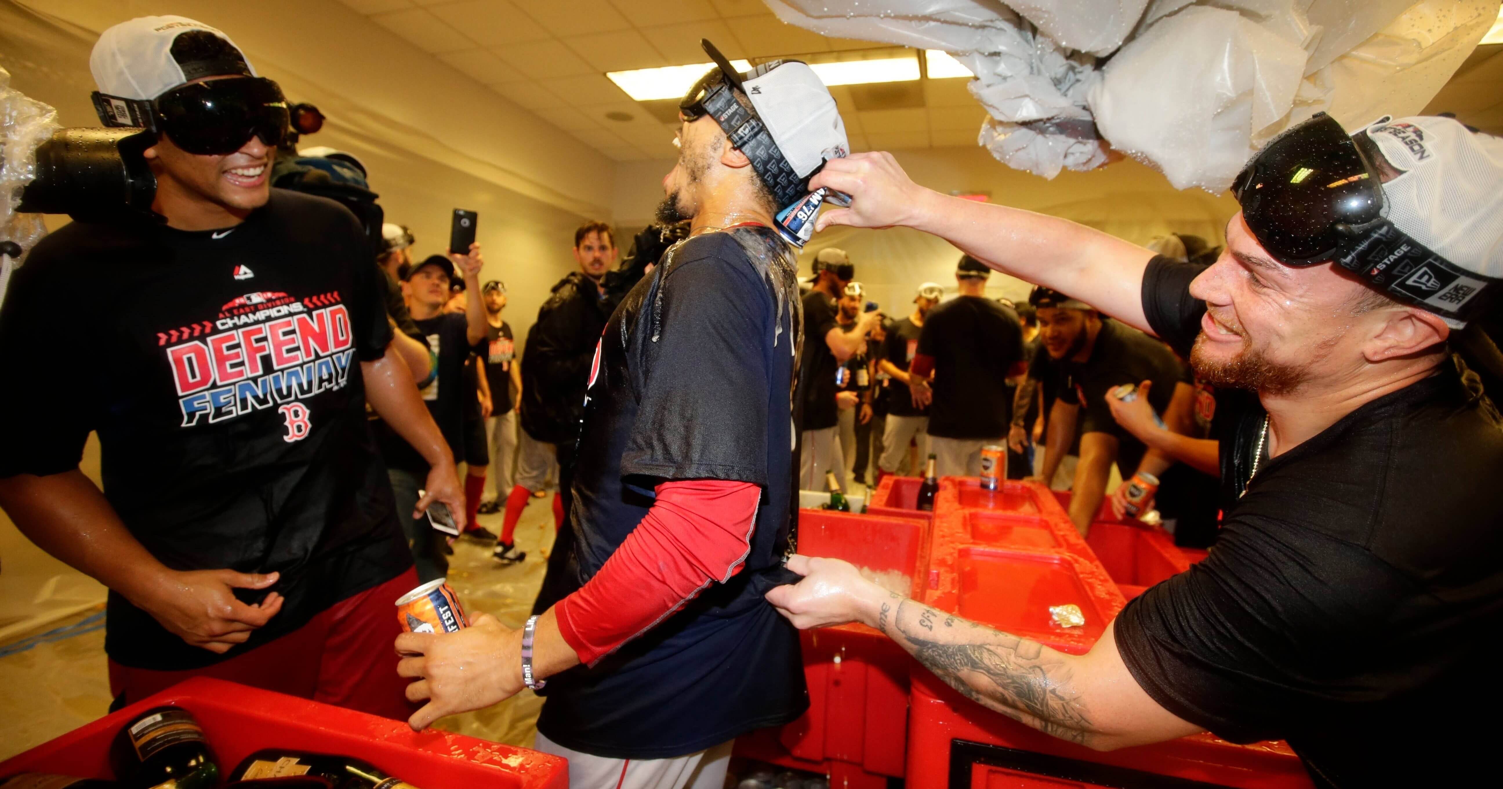 The Boston Red Sox's Mookie Betts, center, celebrates with teammates after they clinched the AL East title on Thursday in New York.