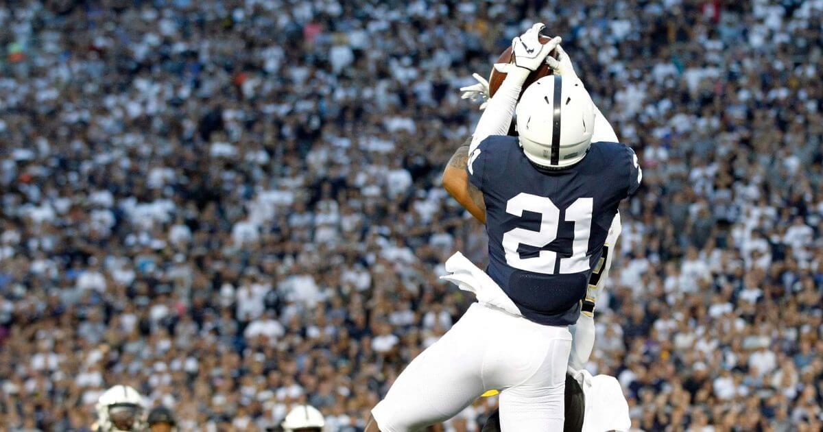 Penn State's Amani Oruwariye (21) intercepts a pass intended for Appalachian State's Corey Sutton (2) in the end zone during overtime Saturday in State College, Pennsylvania. Penn State won 45-38 in OT