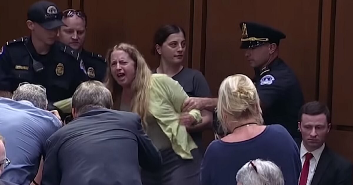 Pro-abortion protesters are escorted out of Supreme Court nominee Brett Kavanaugh's confirmation hearing.