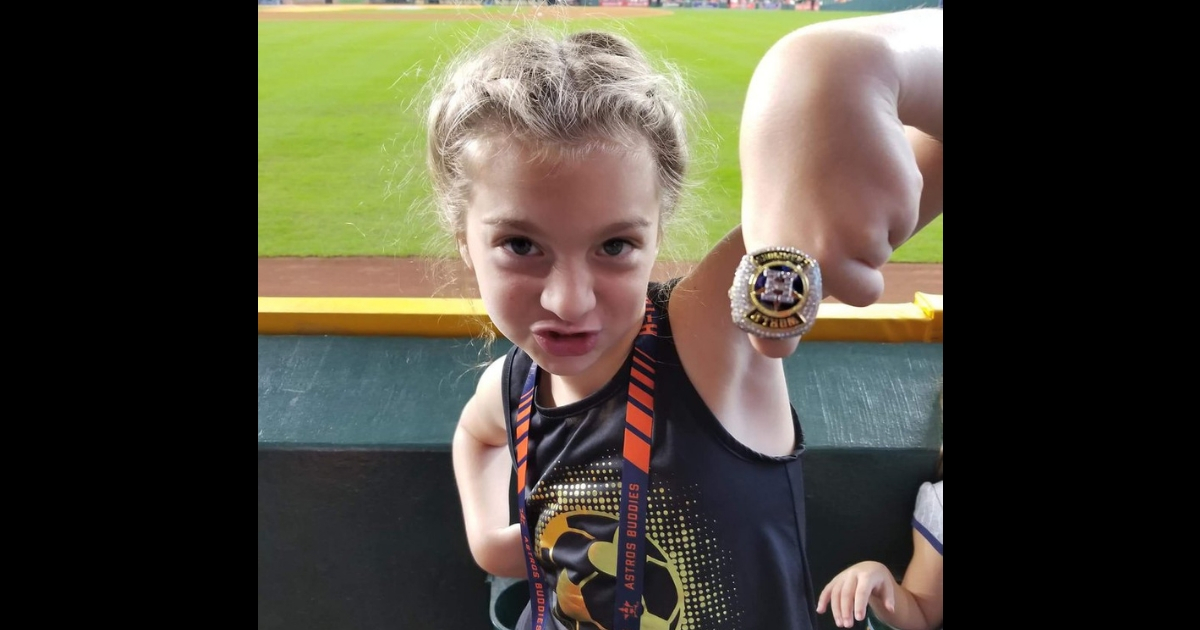 Little girl Astro fan with a championship ring.