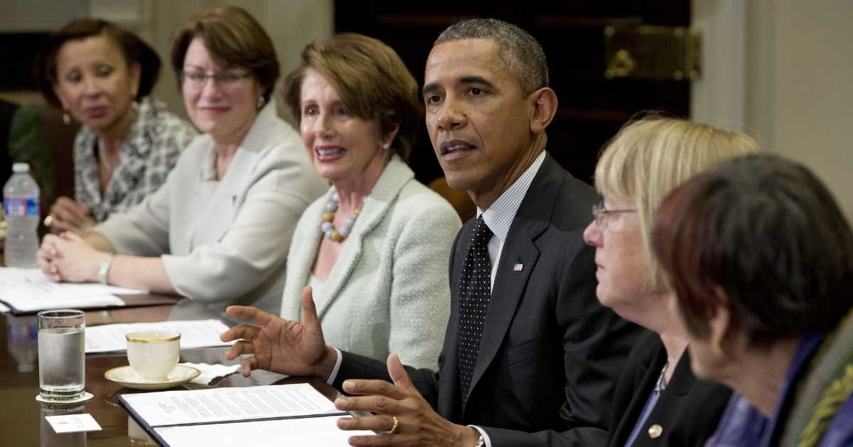 President Barack Obama talks to women of Congress, including House Democratic Leader Nancy Pelosi on March 12, 2014.