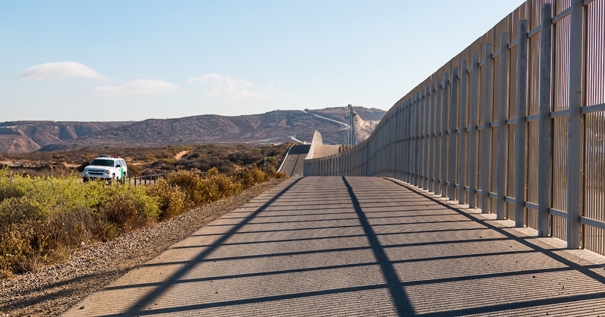 A U.S, Border Patrol vehicle cruises along the border between San Diego, California, and Tijuana, Mexico.