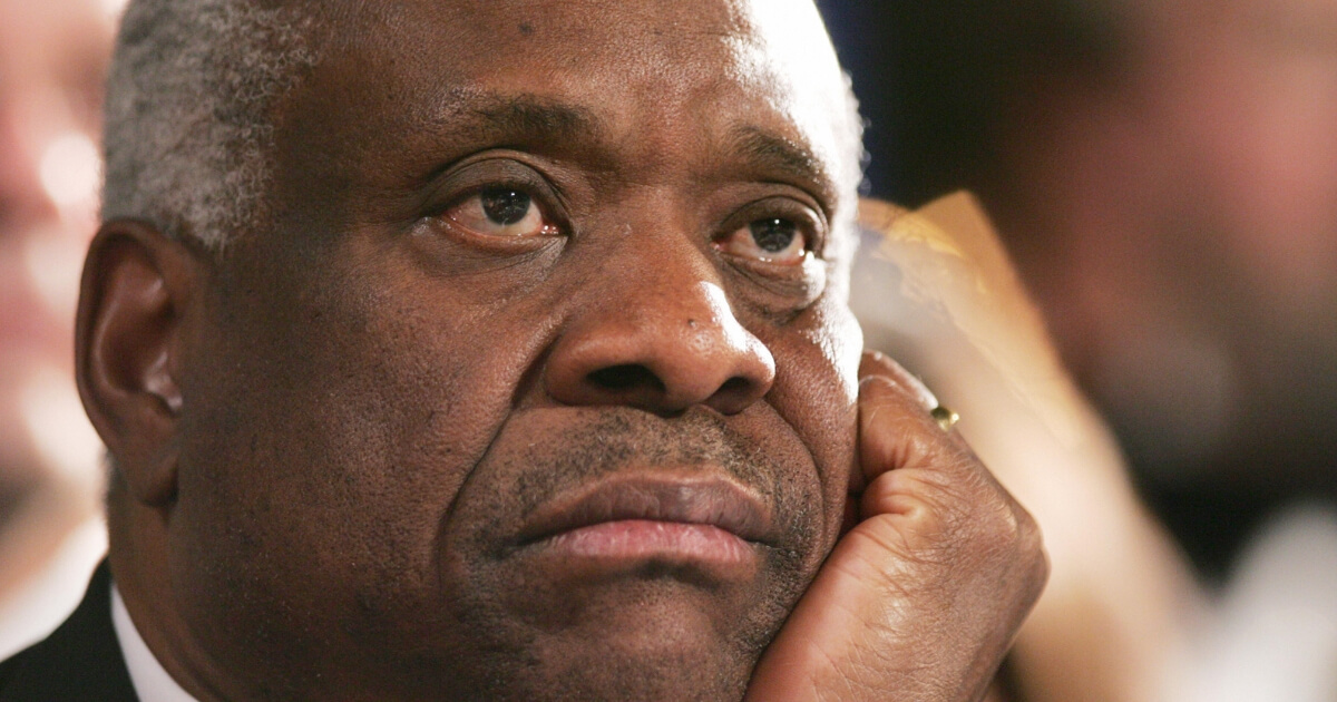 Supreme Court Justice Clarence Thomas listens to a speech from then-President George W. Bush at the Federalist Society's 25th Anniversary Gala Dinner in Washington, DC in 2007.